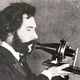 Alexander graham bell 1876 speaking into telephone